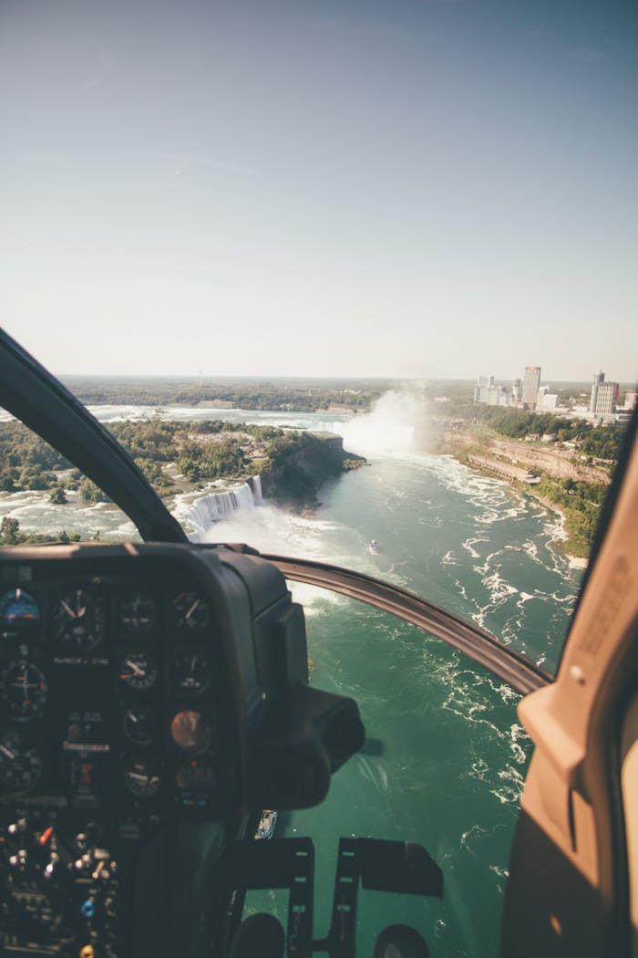 Scenic aerial perspective of Niagara Falls taken from a helicopter in daylight.